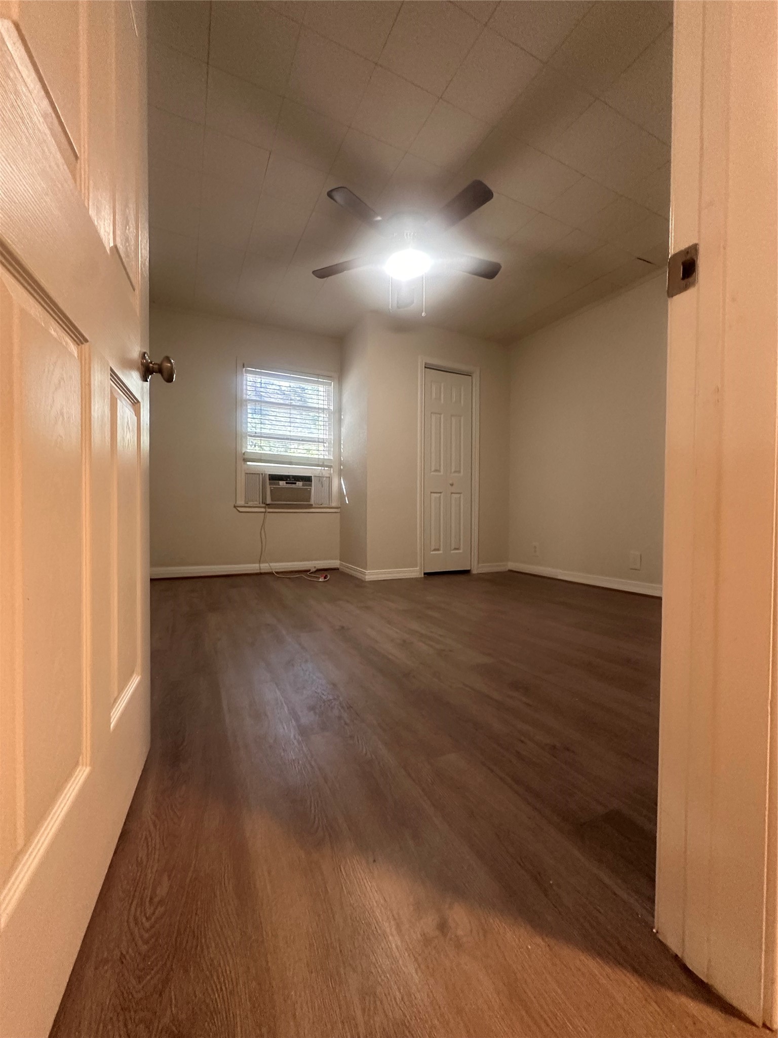 1607 Klauke Street Rosenberg, TX 77471 - Photo 7 of 17 an empty room with wooden floor and windows