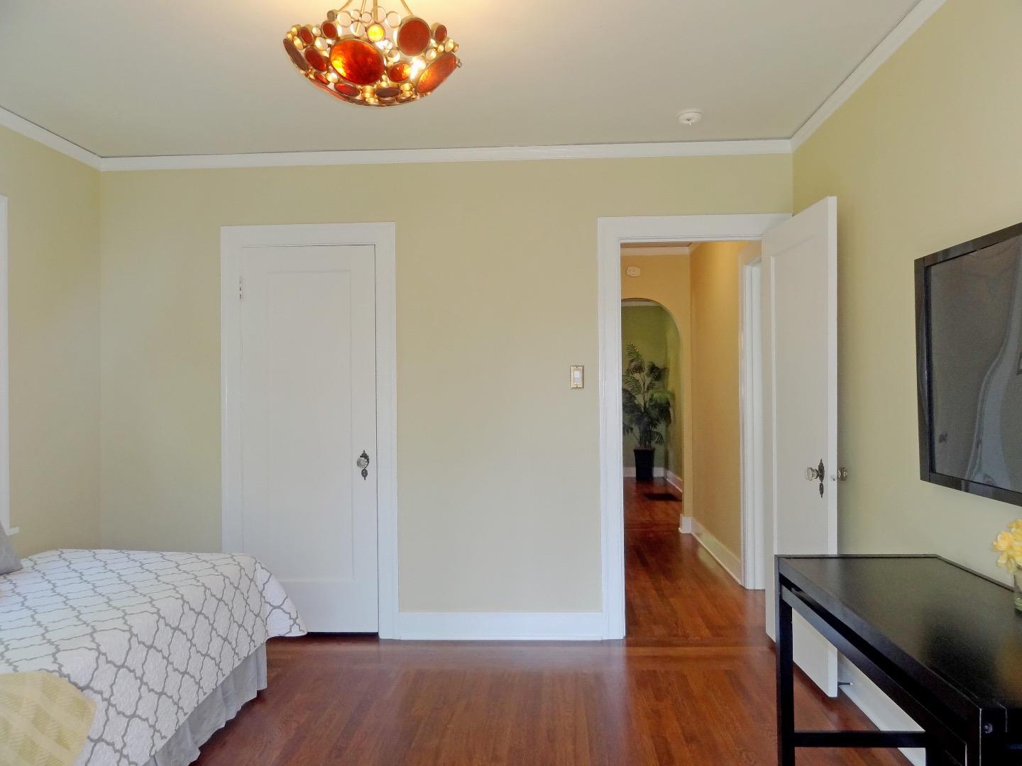 16760 Magneson Loop Los Gatos, CA 95032 - Photo 15 of 20 a bedroom with a bed and a flat screen tv