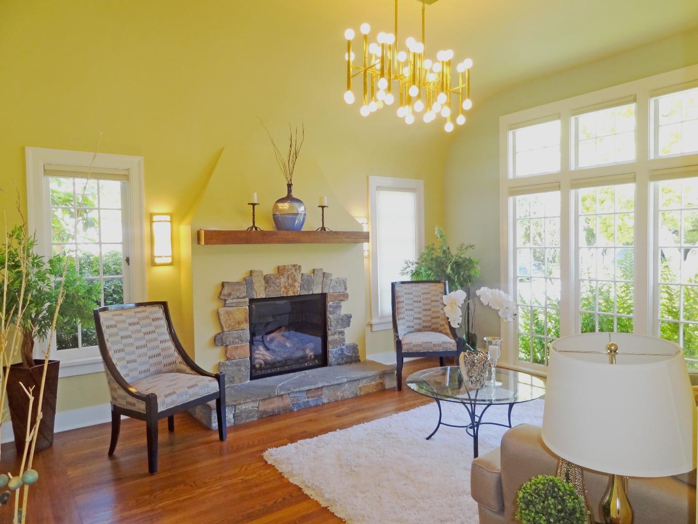 16760 Magneson Loop Los Gatos, CA 95032 - Photo 5 of 20 a living room with furniture a chandelier and a fireplace