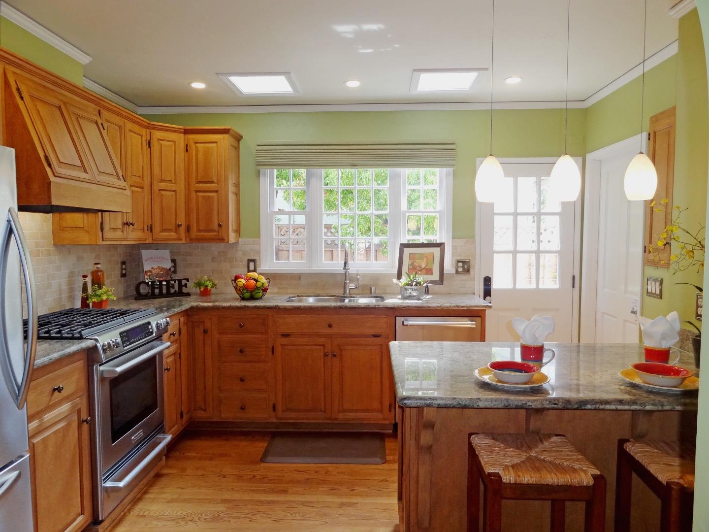 16760 Magneson Loop Los Gatos, CA 95032 - Photo 6 of 20 a kitchen with stainless steel appliances granite countertop a stove a sink and a wooden cabinets
