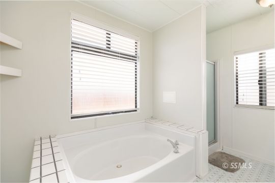 1015 South Mahan Street Ridgecrest, CA 93555 - Photo 21 of 31 a white bath tub sitting next to a window
