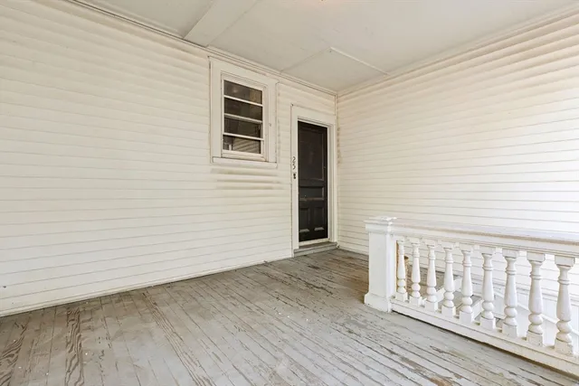 a living room with furniture and large windows