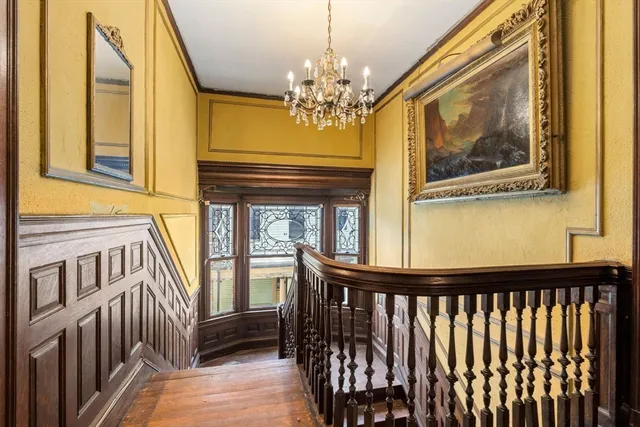 a view of a dining room with furniture wooden floor chandelier