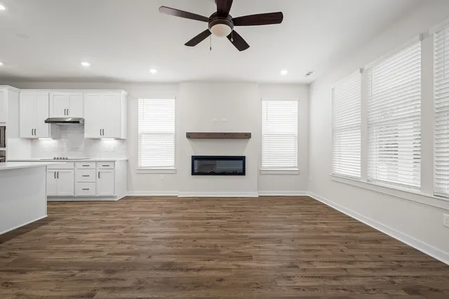 a big room with windows and fireplace