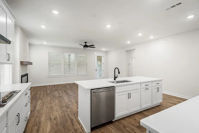 a view of a kitchen with sink and microwave