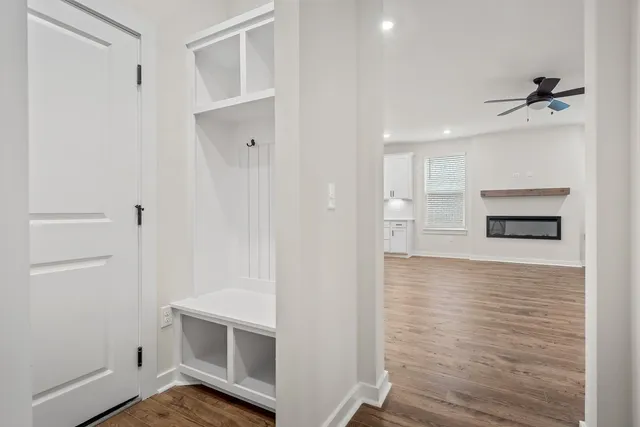 a view of a kitchen with wooden floor and a refrigerator