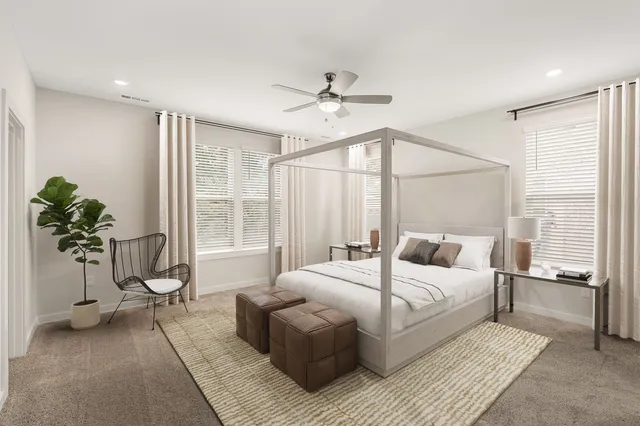 a bedroom with a large bed and potted plant