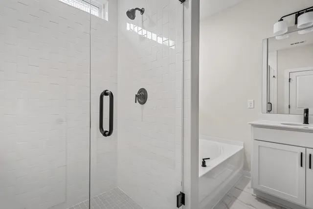 a bathroom with a shower sink and mirror