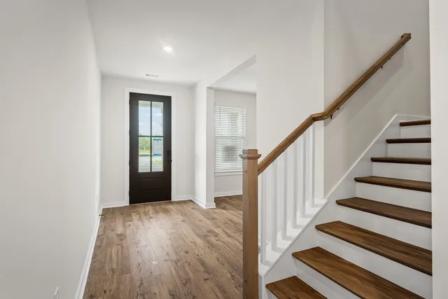 a view of entryway with wooden floor and stairs