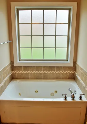a bathroom with a bathtub and window
