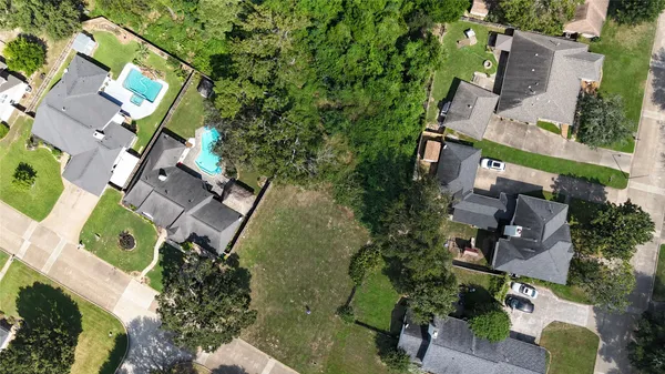 an aerial view of multiple houses with yard