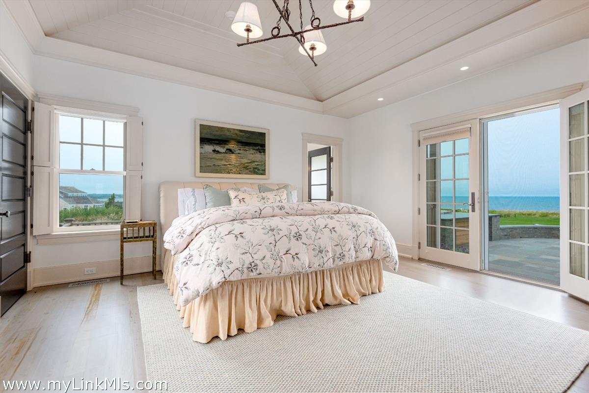 37 Sankaty Head Road Nantucket, MA 02554 - Photo 25 of 65 a spacious bedroom with a bed and a large window