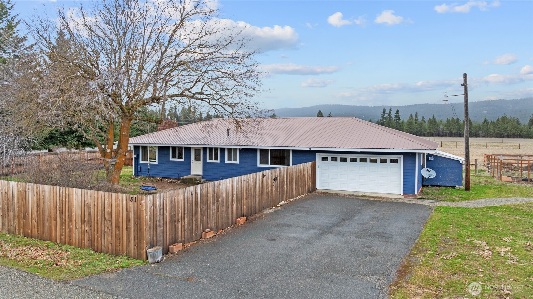 a view of a house with wooden fence
