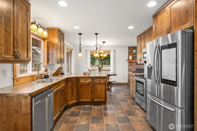 a kitchen with a sink stove and refrigerator