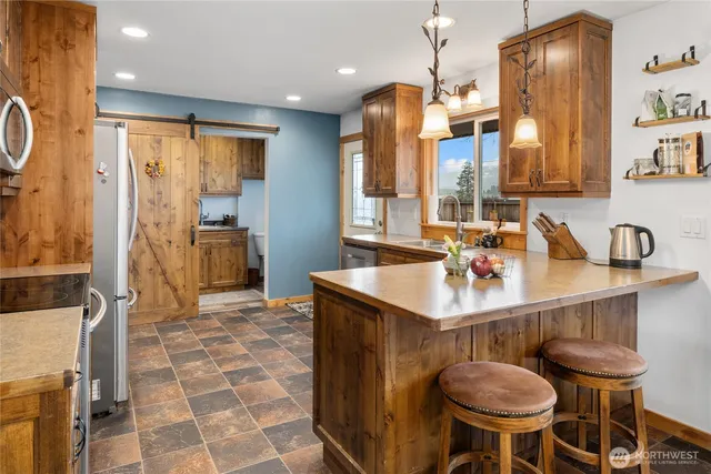 a large kitchen with a table and chairs