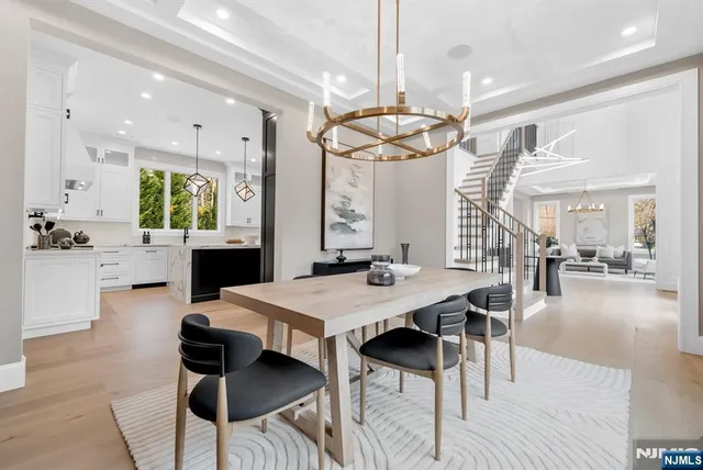 a spacious bedroom with a bed and a chandelier