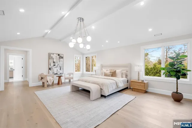 a large kitchen with granite countertop a sink and cabinets