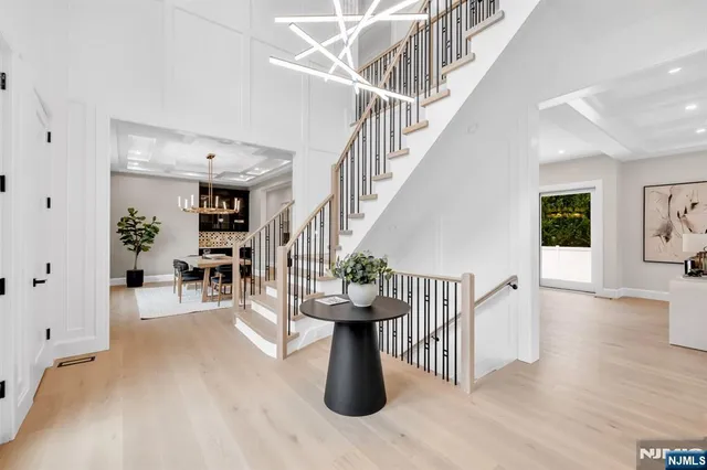 a view of staircase with furniture and wooden floor