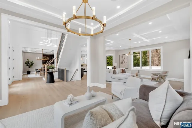 a living room with furniture and a chandelier