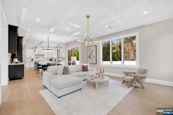 a living room with furniture and a chandelier