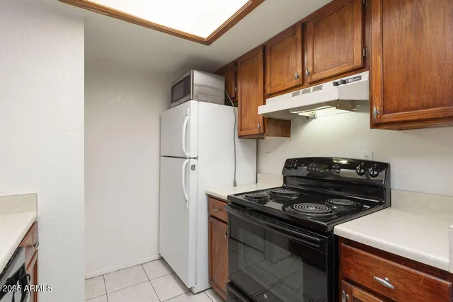 a kitchen with a stove and a refrigerator