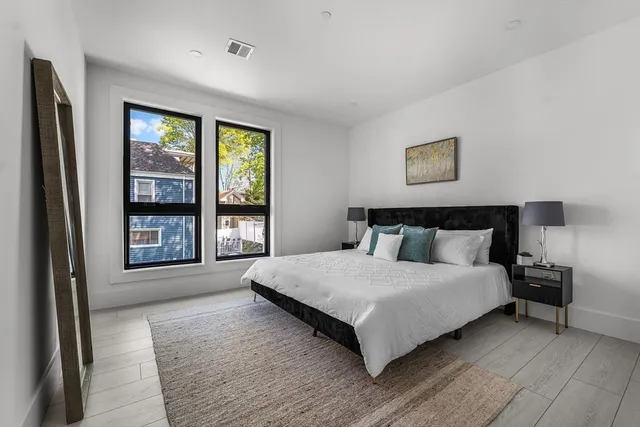 a bedroom with bed and painting on the wall