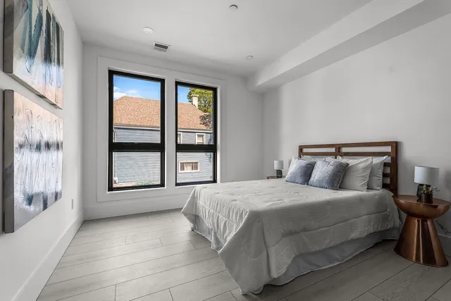 a bedroom with a bed and a mirror