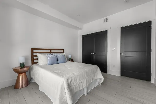 a bathroom with a granite countertop toilet a sink and a mirror
