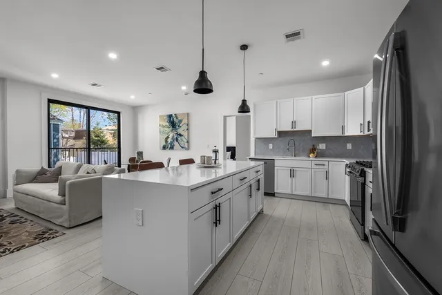 a large kitchen with stainless steel appliances lots of counter top space