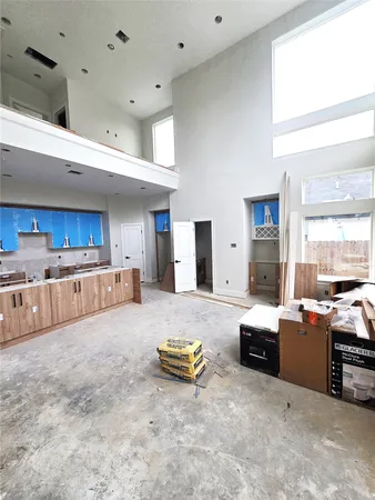 a large kitchen with a large window and stainless steel appliances