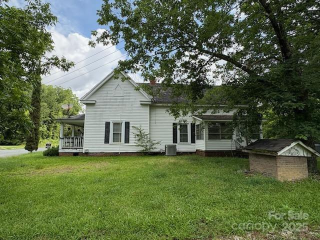 65 Maynard Avenue Ansonville, NC 28170 - Photo 12 of 14 a view of a house with a yard potted plants and a large tree