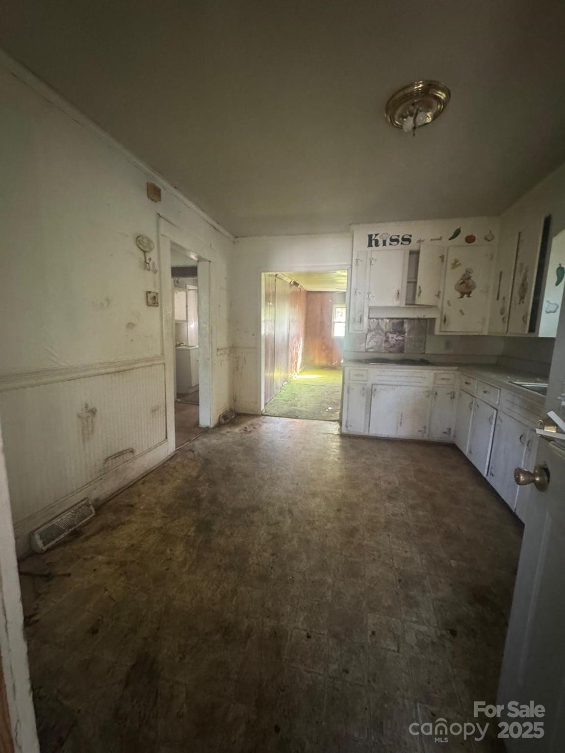 65 Maynard Avenue Ansonville, NC 28170 - Photo 7 of 14 a large kitchen with cabinets and a fireplace