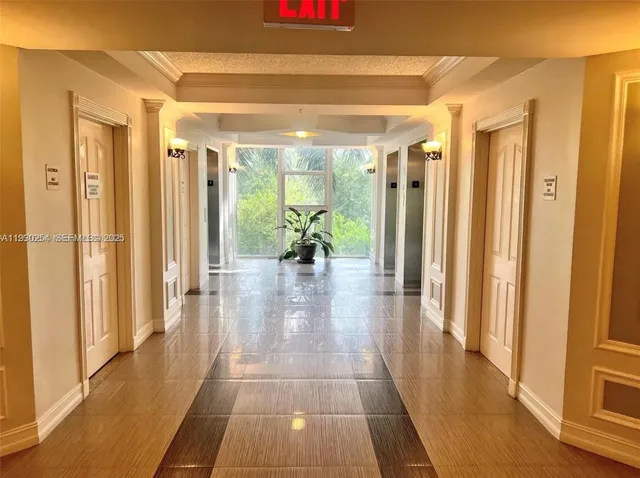 a hallway with wooden floor and furniture