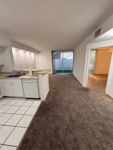 a view of a kitchen with a sink cabinets and a window