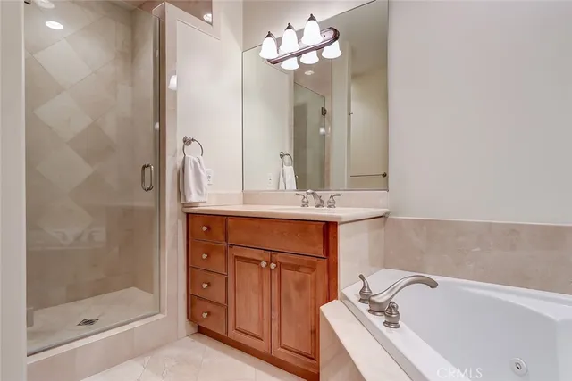 a bathroom with a bathtub shower sink and mirror