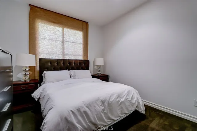 a bed sitting in a bedroom next to a window