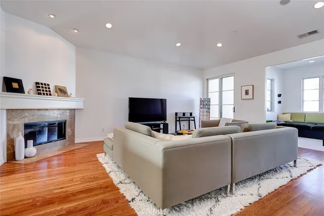 a living room with furniture a fireplace and a flat screen tv