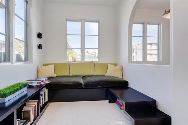 a living room with a bed furniture and a window