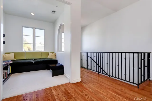 a living room with a bed furniture and a window