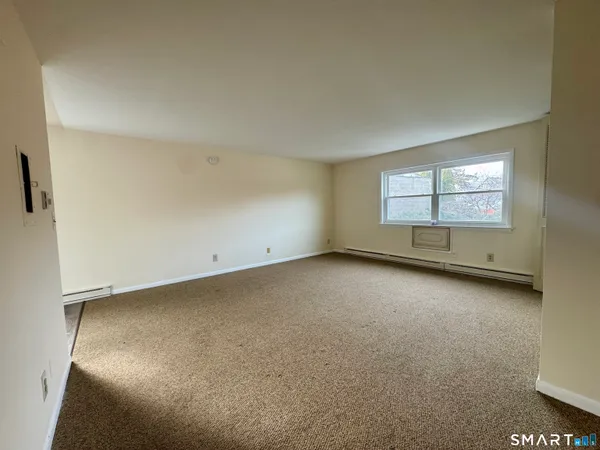 an empty room with a empty space and windows