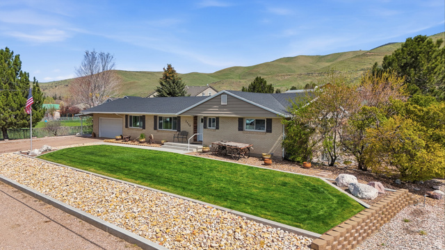 2420 West Old Hwy Road Morgan, UT 84050 - Photo 2 of 54 Ranch-style home featuring a mountain view, a garage, a front lawn, brick siding, and driveway