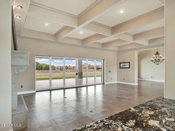 a view of a kitchen with stainless steel appliances kitchen island granite countertop a sink and cabinets