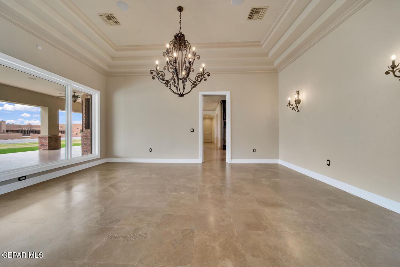 7 Cielo Del Este Anthony, NM 88021 - Photo 27 of 95 a view of an empty room with a chandelier