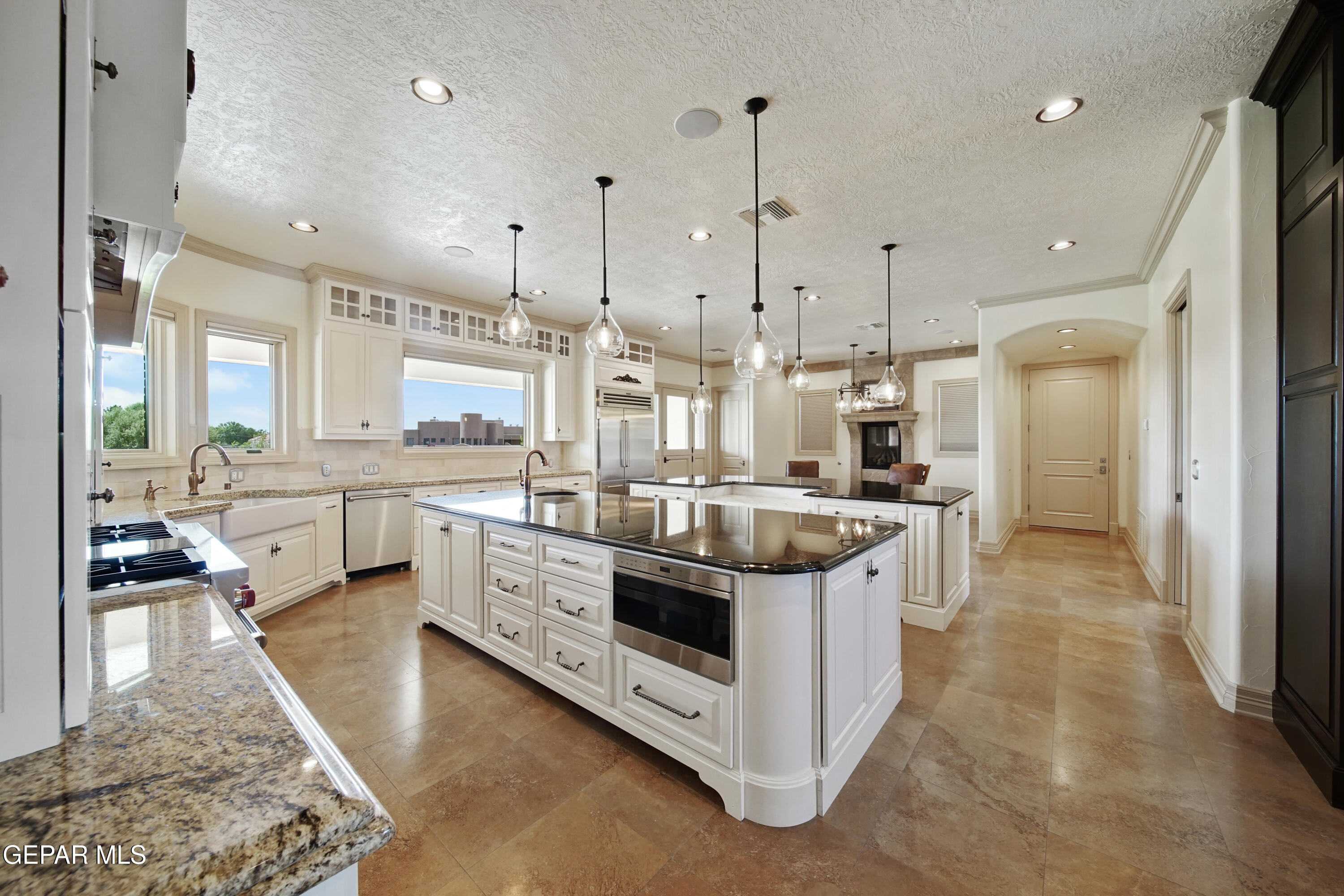 7 Cielo Del Este Anthony, NM 88021 - Photo 28 of 95 a large kitchen with stainless steel appliances kitchen island granite countertop a lot of counter space and a wooden floor