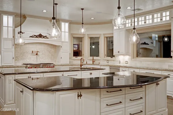a bathroom with a granite countertop sink and a large mirror