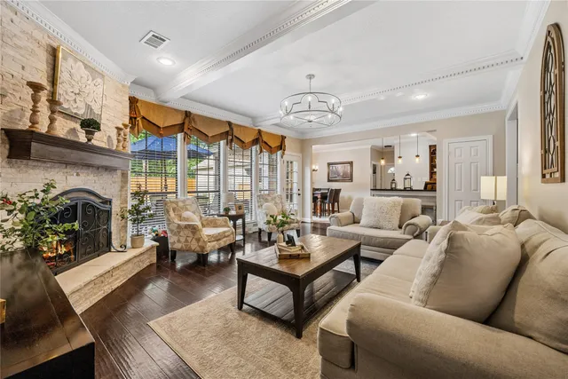 a living room with furniture fireplace and a large window