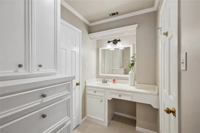 a spacious bedroom with a large bed and a chandelier