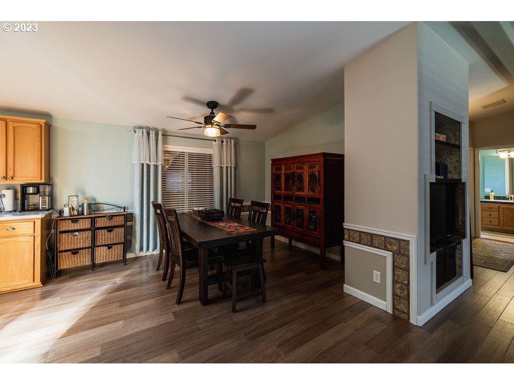 369 Gun Club Road, Unit 16 Woodland, WA 98674 - Photo 12 of 44 a view of a dining room with furniture and wooden floor