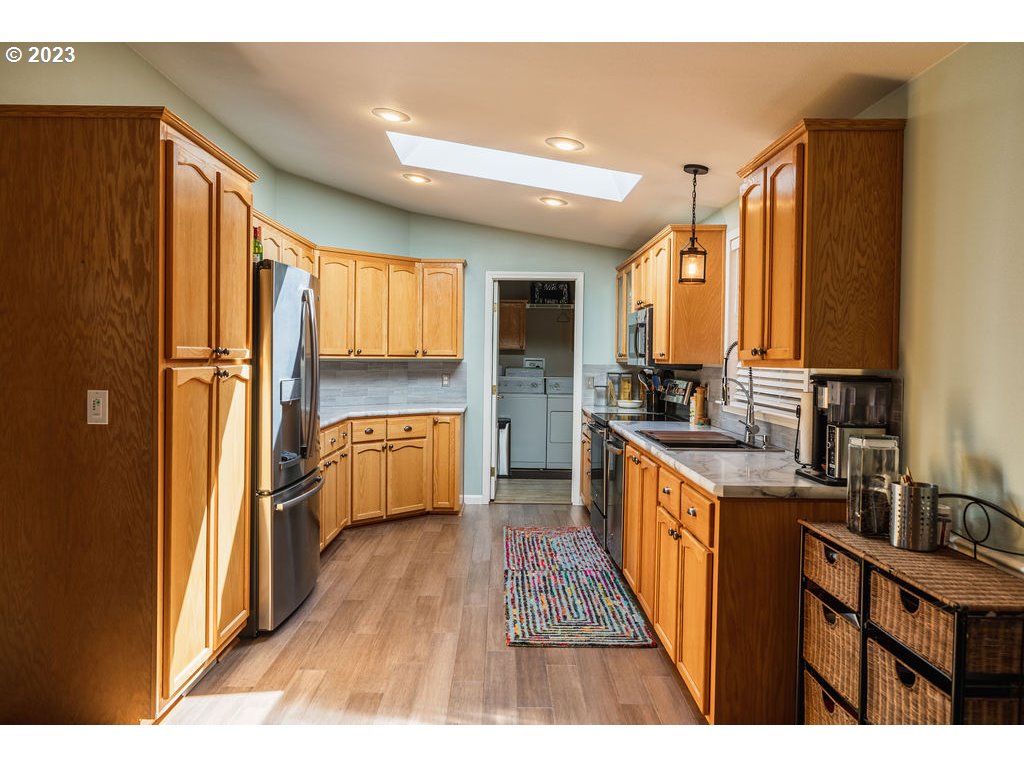 369 Gun Club Road, Unit 16 Woodland, WA 98674 - Photo 13 of 44 a kitchen with stainless steel appliances a refrigerator and a sink