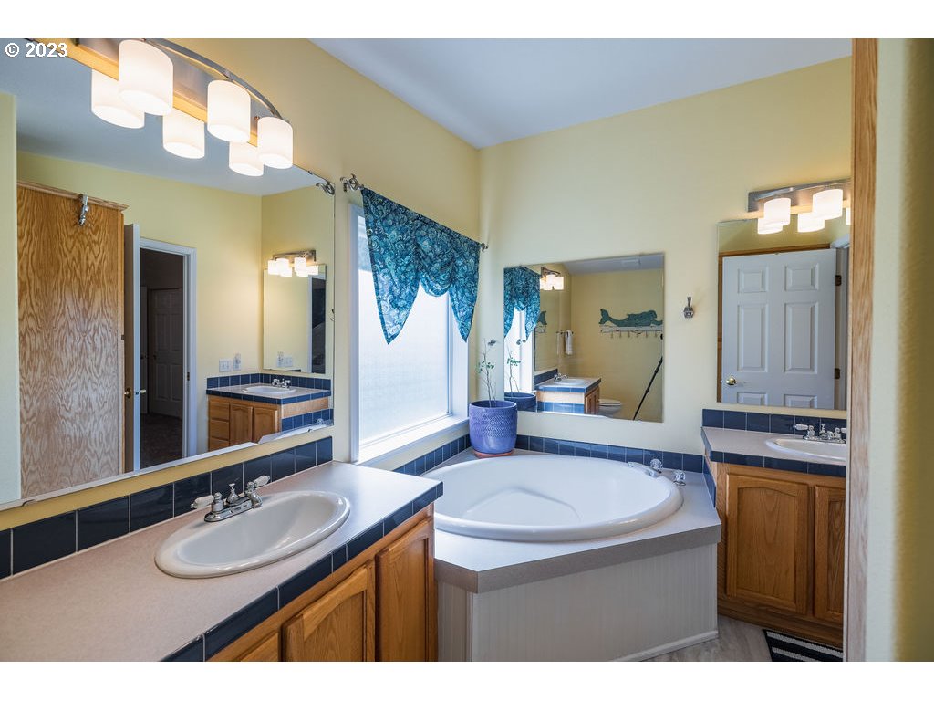 369 Gun Club Road, Unit 16 Woodland, WA 98674 - Photo 21 of 44 a bathroom with a granite countertop sink and a mirror